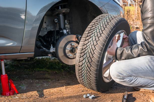 istock Man is changing summer car wheel, tire before winter 1091633672