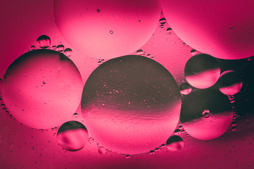 Space or planets universe cosmic abstract background. Abstract molecule structure. Water bubbles. Macro shot of air or molecule. Abstract space pink and black gradient background.