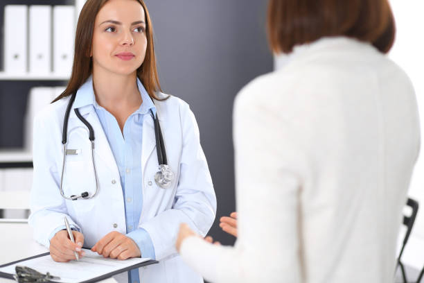 istock Doctor and  patient  discussing something while standing near reception desk in emergency hospital. Physician at work in clinic. Medicine and health care concept 1091636414