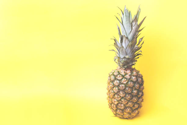 istock Ripe pineapple on a yellow toned background 1091640034