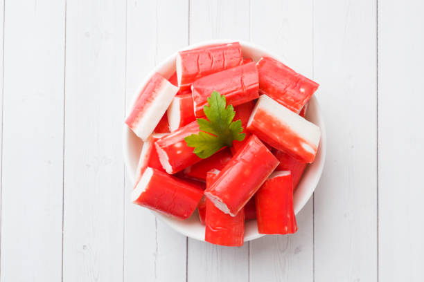 istock Salad crab sticks in a plate on a white table. 1091644520