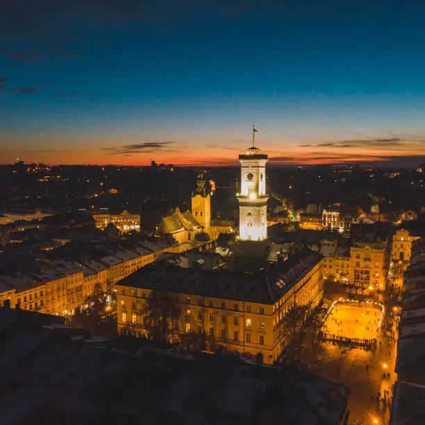 Photo of aerial view of capital building in center of european city at sunset in winter time