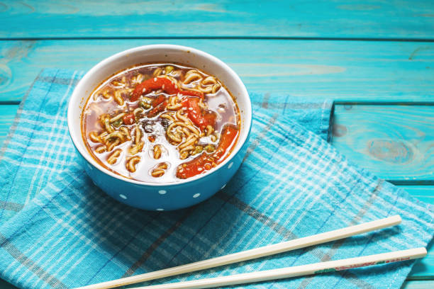 istock Fresh asian vegetable soup with noodles on wood background 1091648174