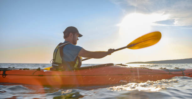 istock Kayaker rowing in sea 1091657386