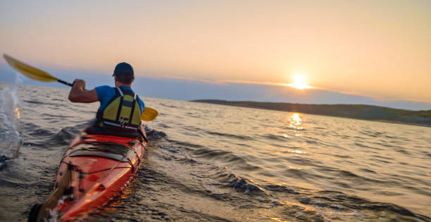 istock Kayaker rowing in sea 1091657446