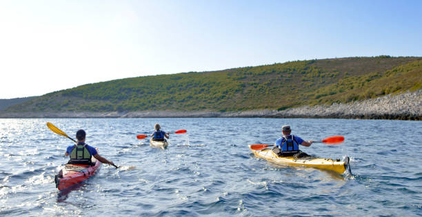 istock Kayakers rowing together in sea 1091657448