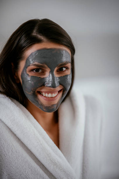 istock Young girl with purifying black face mask 1091660862