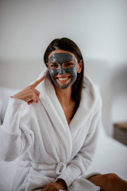 istock Young girl with purifying charcoal face mask 1091661514