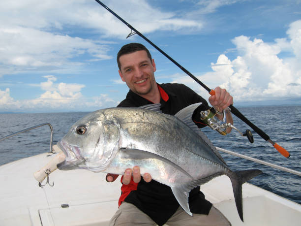 fishing scene, catch of fish, trevally jack (caranx) - animal catch of fish catching sport imagens e fotografias de stock