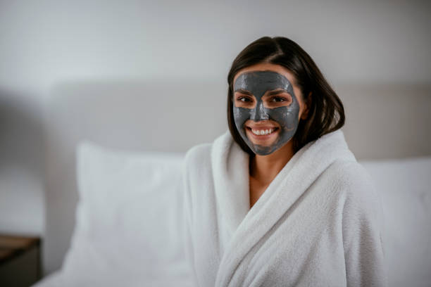 istock Young girl with purifying black face mask 1091661648