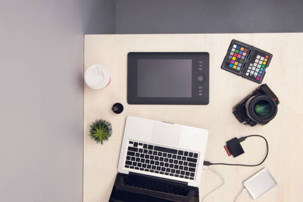 istock Top view laptop and camera workspace of photographer. 1091661772