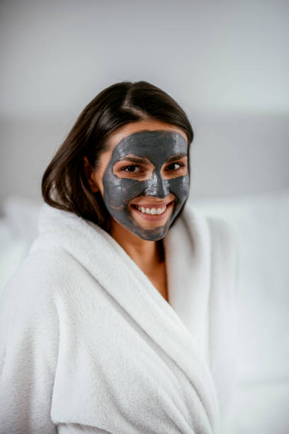 istock Young girl with purifying black face mask 1091661840