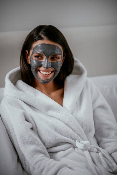 istock Young girl with purifying black face mask 1091663642