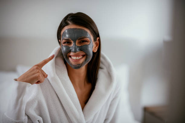 istock Young girl with purifying charcoal face mask 1091664144