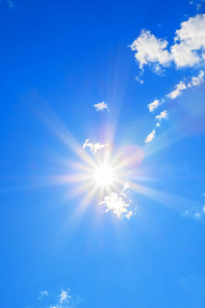 istock Sun with beautiful beams in the blue sky with some clouds 1091668082