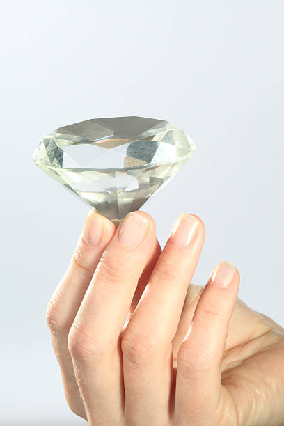 istock woman hand with diamond 109167264