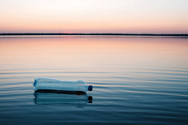 istock Concept of pollution, creative background. A plastic bottle floating in the ocean, non-decomposable plastic, pollution of the environment. Copy space. 1091676168