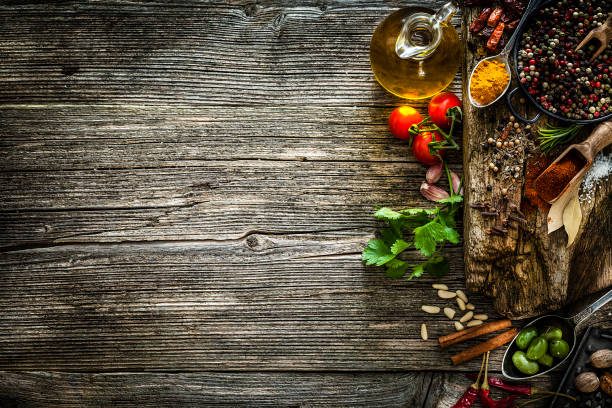 istock Cooking backgrounds: spices and herbs making a border on rustic wooden table 1091677190