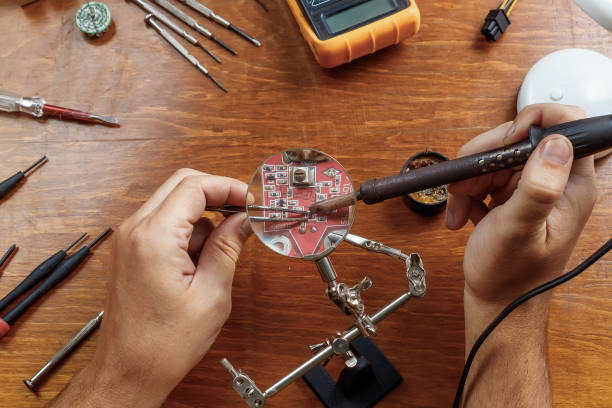 istock Workplace with soldering iron, microcircuit, magnifying glass, magnifying glass, measuring instruments. Electronics repair, master. 1091681100