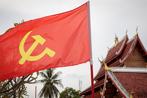 Red flag with hammer and sickle outside a temple in Luang Prabang, the former capital of Laos