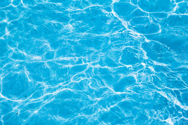 istock Blue ripped water in swimming pool with sunny reflections. 1091685860