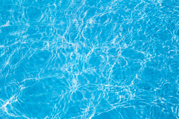 istock Blue ripped water in swimming pool with sunny reflections. 1091685866