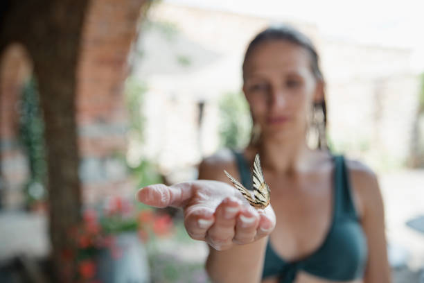 Young Woman Holding Butterfly