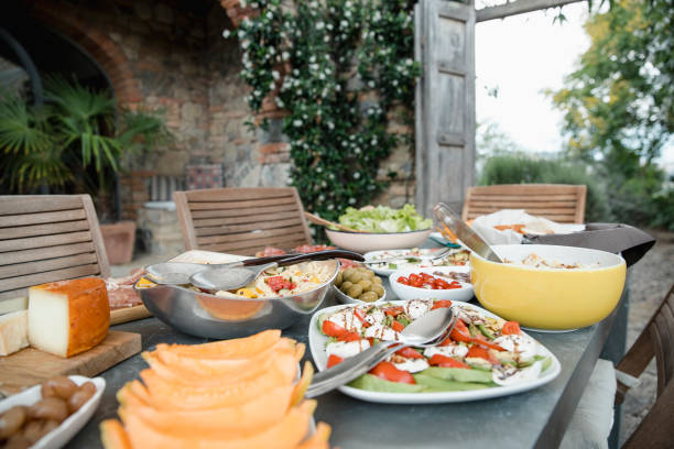 Italian Lunch at the Villa Italian lunch buffet on a dining table in the garden of a villa. outdoor dining photos stock pictures, royalty-free photos & images