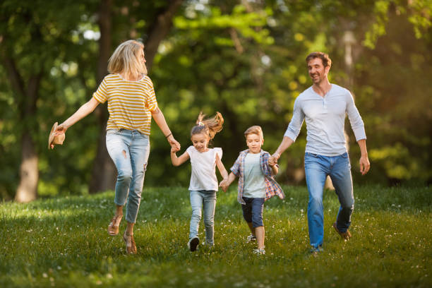 istock Carefree family having fun while running in the park. 1091689628