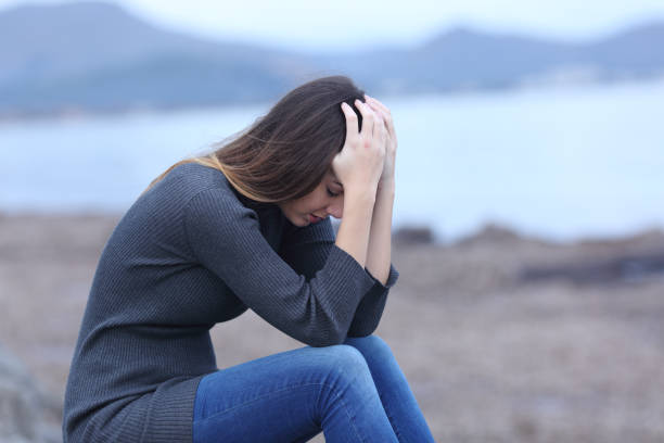 istock Sad woman complaining sitting on the beach 1091692950
