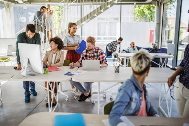 istock Large group of creative people cooperating while working in a modern office. 1091694192