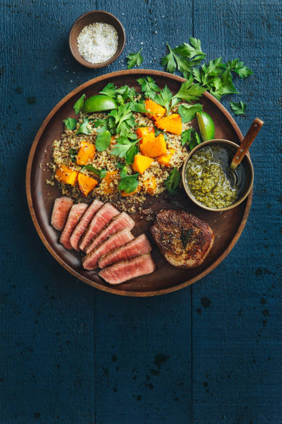 Filet mignon with chimichurri and quinoa salad with caramelised and mashed pumpkin