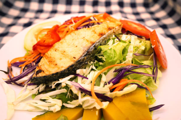 istock grill salmon salad with green leaf and vegetable 1091698032