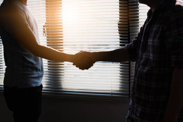istock Success concept, silhouette business people shake hand near window 1091700906