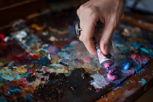 istock Artist's palette with multi-colored smeared colors and one brush. 1091701004
