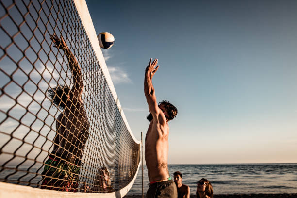 istock Young man blocking his friend while playing beach volleyball in summer day. 1091703390