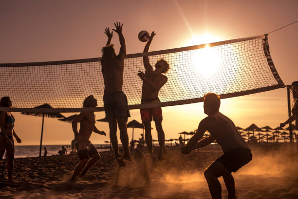 istock Young friends having fun while playing beach volleyball at sunset. 1091704038