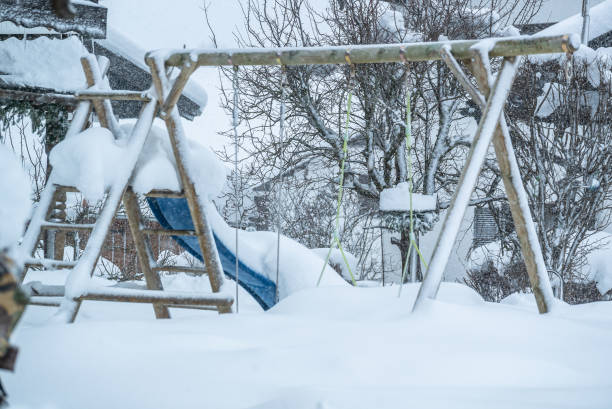 istock Snow covered Playground with swing and slide 1091704654