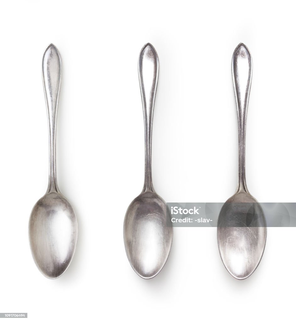 old silver spoon isolated on white with clipping path included old silver spoon with different light isolated on white background with clipping path included, high angle view Spoon Stock Photo