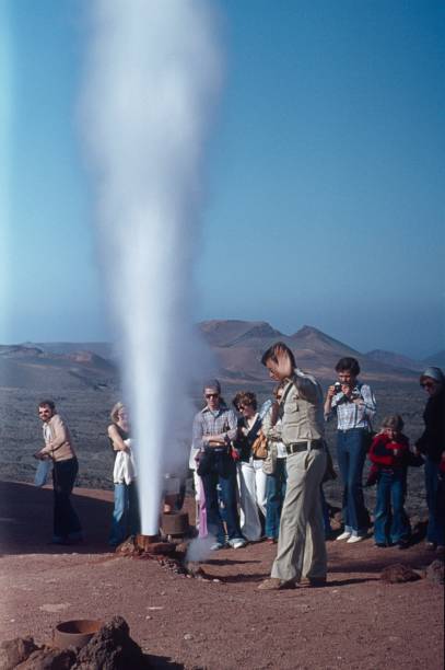 Lanzarote, Canary Islands, Spain, 1975. Steam Fountain (geyser). Tourists with guide at a geothermal spring on the volcanic island Lanzarote.