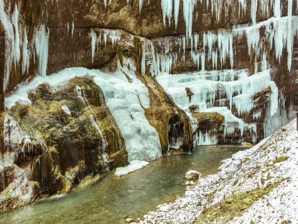 istock Frozen waterfall with huge beautiful icicles hanging from the rocks. 1091710472