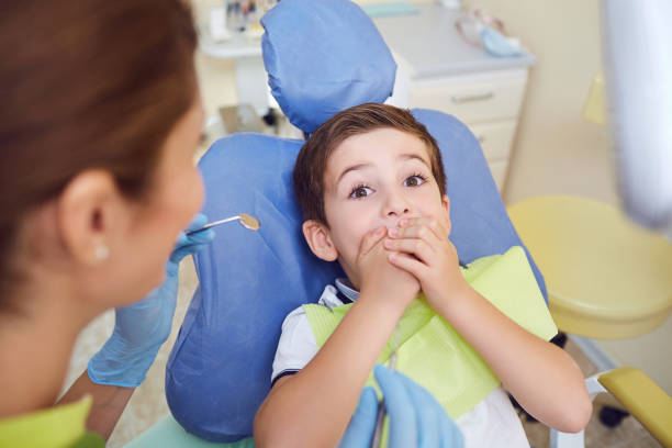 istock Frightened child boy in dental clinic. 1091710560