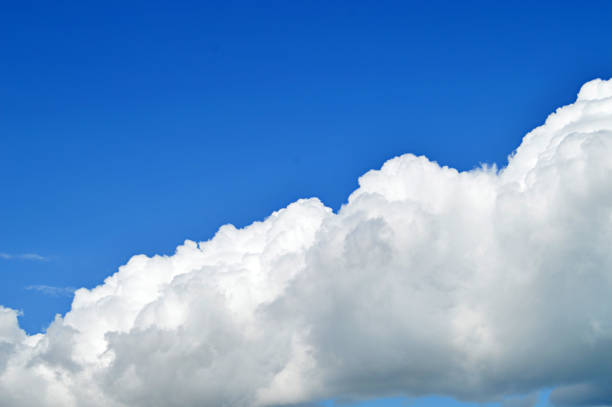 istock A horizontal click of white bright clouds in open bright blue sky. 1091714296