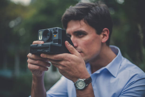 istock Man takes photo with old camera 1091715612