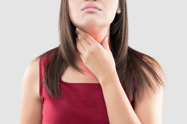 Sore throat Asian woman with a sore throat or thyroid gland against the gray background. Acid reflux or Heartburn, Neck pain, People body problem concept lymphoma photos stock pictures, royalty-free photos & images