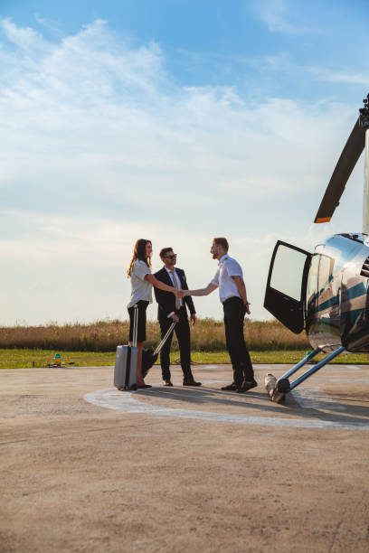 istock Passengers welcomed by helicopter pilot with handshake 1091719366