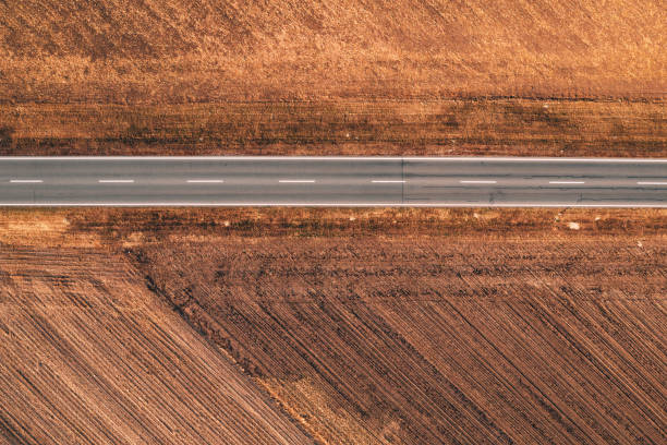 istock Aerial view of empty road through countryside 1091728116