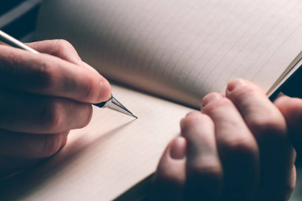 istock Close up of woman's hand writing in notebook 1091729758