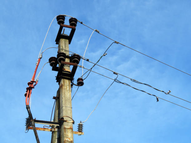 istock Power line post with electrical wires and capacitors isolated on blue sky background 1091733842