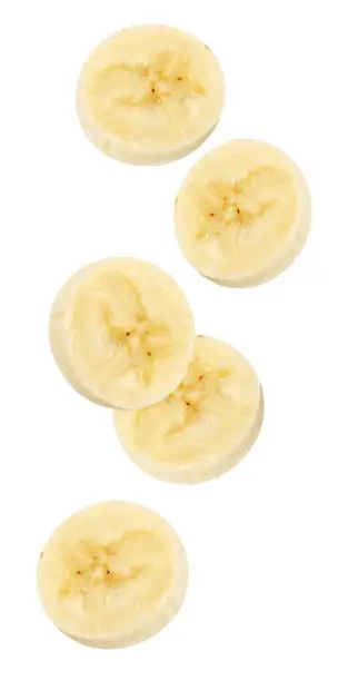 Photo of Isolated flying banana. Peeled falling banana slices isolated on white, with clipping path